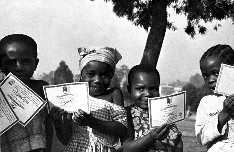 Children holding smallpox vaccination certificates