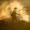 A firefighter walks near the smoldering remains of homes during a fire that reached San Bernadino, California, in 2019.