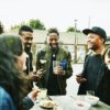 friends drinking and laughing at an outdoor bar