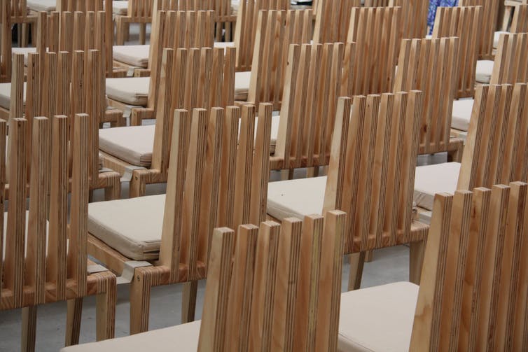 Rows of modern wooden chairs.