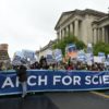 people with signs at a March for Science in DC