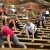 people stretching while socially distanced in stadium seats