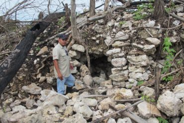 man beside a rocky mound