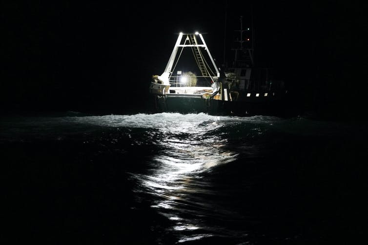 A fishing boat at night.