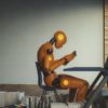 A humanoid robot reading a book.