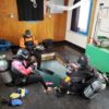 SCUBA divers sit around a square hole cut in Antarctic ice