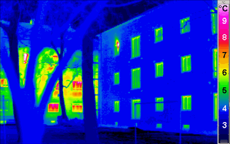 A thermal image of a house showing hotspots of heat leaking out of windows.
