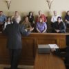 Lawyer speaking to jurors in a courtroom