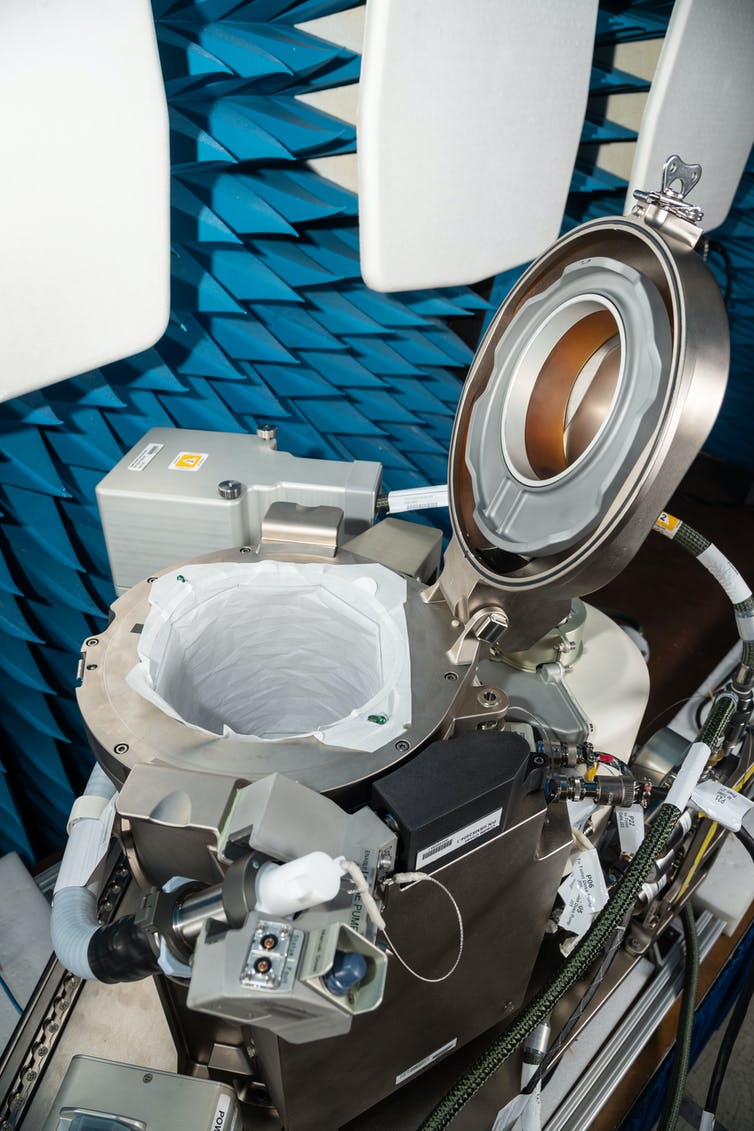 The new NASA Universal Waste Management System has a steel lid, controls and many tubes surrounding the toilet bowl.