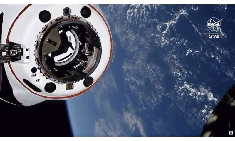 Old SpaceX capsule delivers new crew to space station