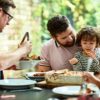 two dads and two kids eating together