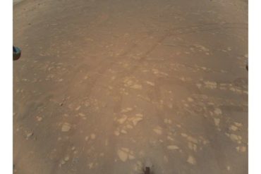 This NASA photo obtained April 25, 2021 shows the first color image of the Martian surface taken by an aerial vehicle while it w