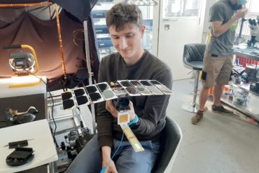 A member of the Alba Orbital team holds a Unicorn-2 satellite.
