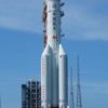 A large white rocket on a launch pad.