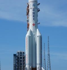 A large white rocket on a launch pad.