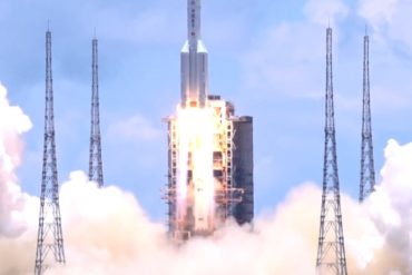 A white rocket lifting off in a cloud of smoke and fire.