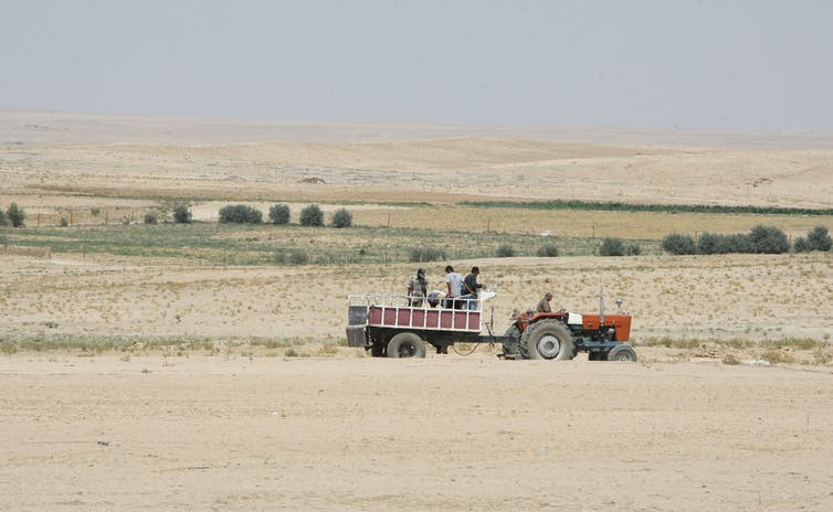 Dry, empty landscape with a tractor