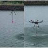 A drone dips a sample container in a river.