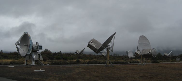 A group of satellite dishes pointing in various directions.