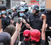 Protesters kneel in front of police during a demonstration on Broadway near New York City's Union Square, June 2, 2020.