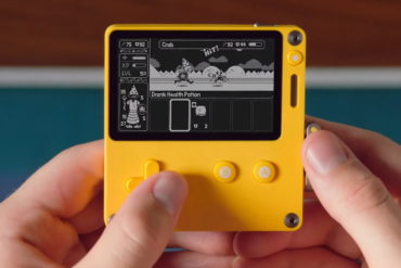 The Playdate handheld with a person playing a game on it.