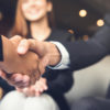 Businessmen shaking hands after meeting in a cafe