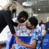 U.S. First Lady Jill Biden gives comfort to a patient at a vaccination clinic