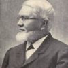 Profile photo of Bishop with a beard and glasses and wearing a suit
