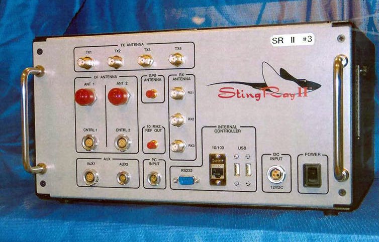 An electronic device with handles on either side of a front panel containing buttons and lights and a graphic representation of a stingray