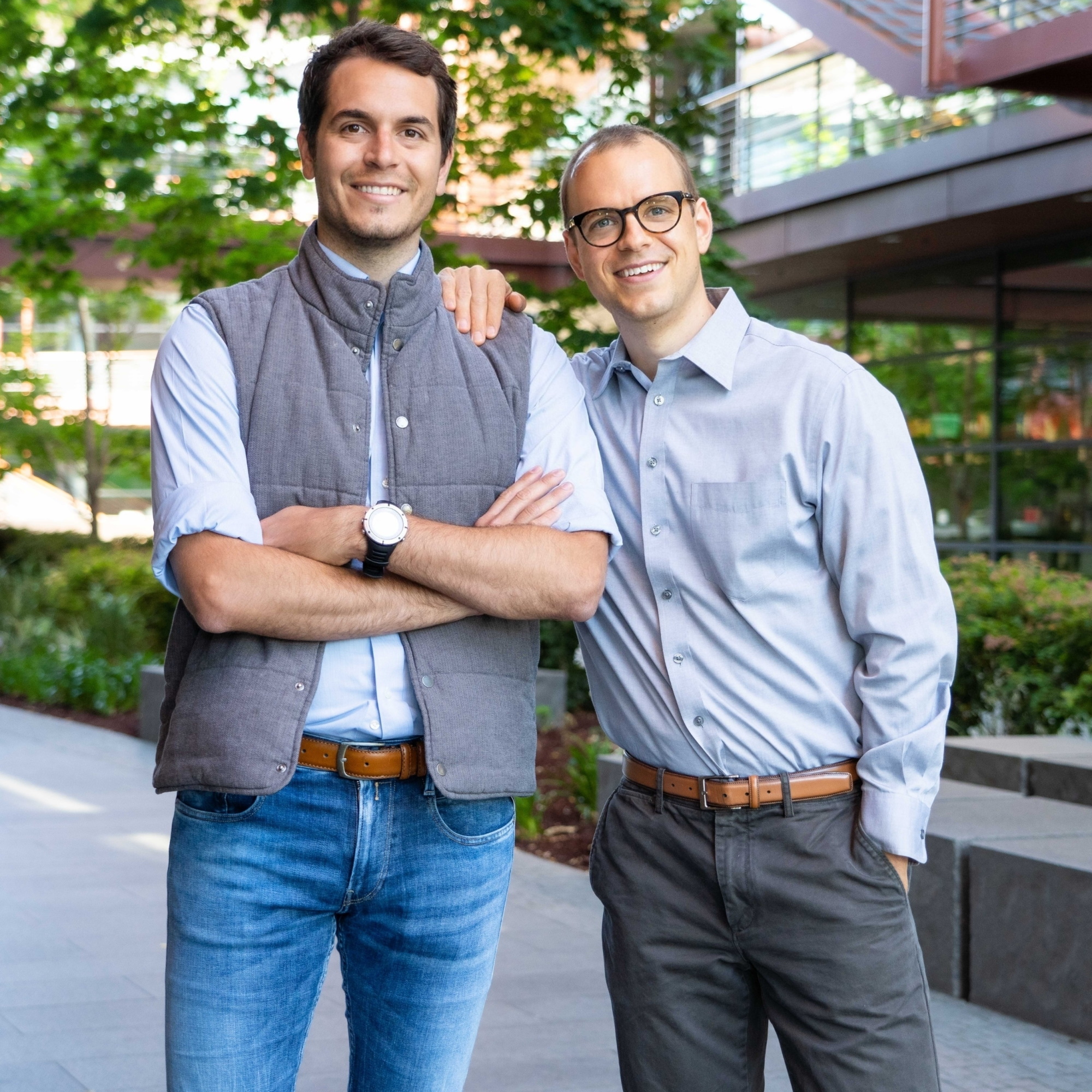 Orestis Vardoulis, left, and Urs Naber, co-founders of Zeit, pose with each other in a courtyard.