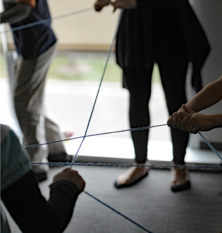 An ice-breaker exercise involving tossing strings of yarn to one another