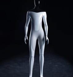 A humanoid robot with a black head and shoulders and white body with the name Tesla across its chest