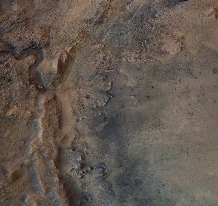 A satellite image showing a delta shaped rock formation on the surface of Mars.