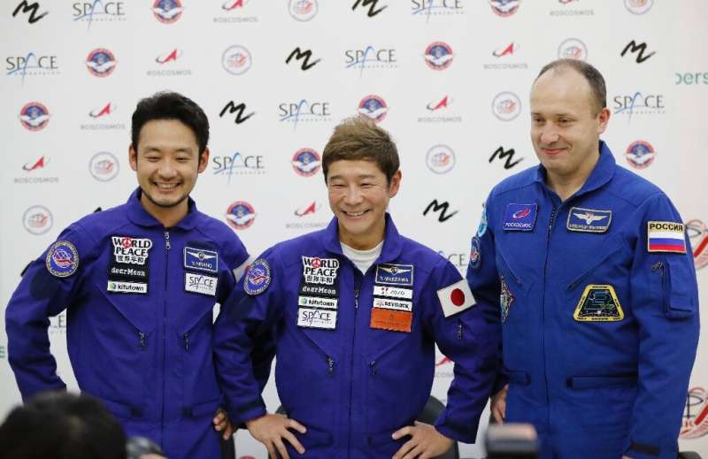 After a decade-long pause, Russia will send two Japanese tourists, including billionaire Yusaku Maezawa (C),to the ISS in Decemb