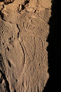 etched outline of a figure instone