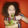 A woman eating a healthy salad.
