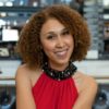 Krystal Covington, a woman with medium-length, curly hair, smiles at the camera.