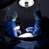 preparing for operation in darkened surgical suite