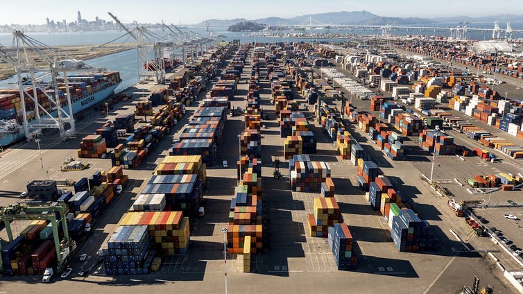 Thousands of shipping containers stacked on a dock.