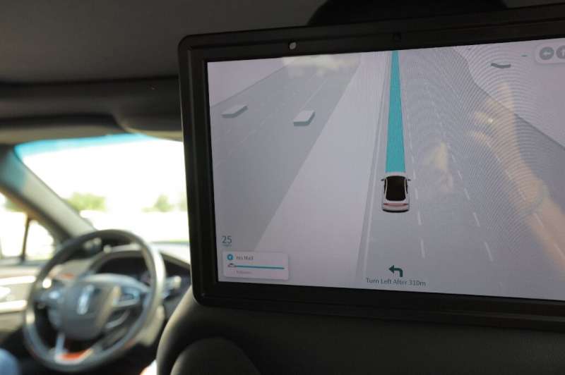 Passengers' view of monitor showing road navigation, from the interior of a self-driving taxi being used in a tech demonstration