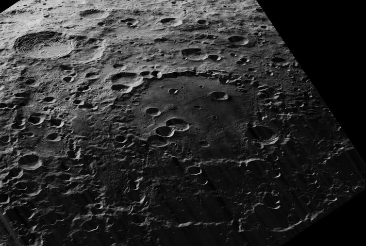 An image showing a large crater on the surface of the Moon.