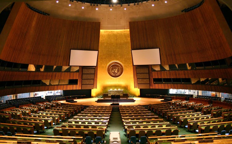 A large room with many seats and a large dais.