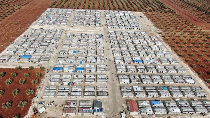 Solar panels on the roofs of cement shelters for Syrian families displaced by conflict in the village of Niyarah