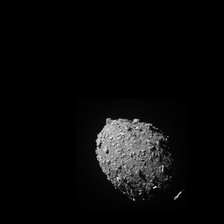 A gray, oblong, rocky object floating against the black backdrop of space.