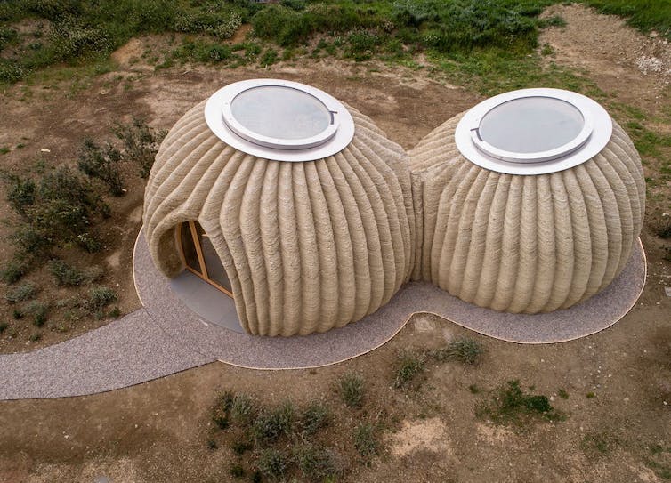 Aerial view of two rounded dwellings made from clay.