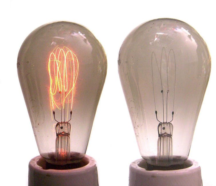 Two lightbulbs next to each other with one showing a glowing filament.