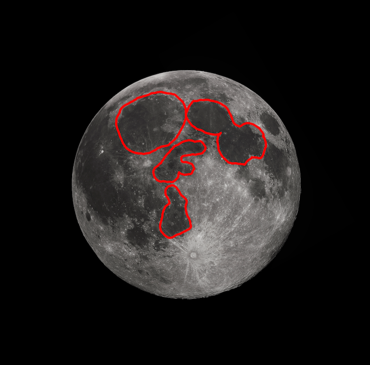 The Moon, with the dark regions outlined in red, showing a face with two ovals for eyes and two shapes for the nose and mouth.