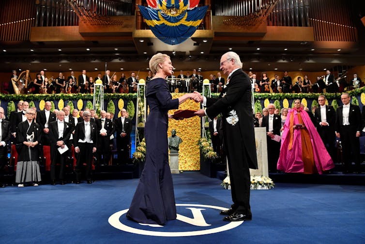 woman and man in formal dress at awards ceremony