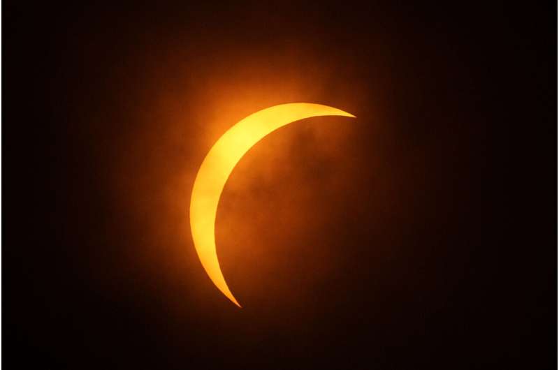 A total solar eclipse races across North America as clouds part along totality