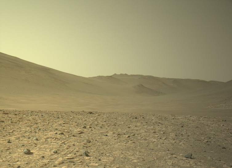 A rocky brown landscape and a yellowish sky.